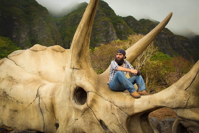 Jordan Vogt-Roberts rests among the props on the set of “Kong: Skull Island.” (Legendary Entertainment)