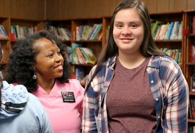 Melanie Gamble, director of programs, Vizavance; celebrates with Yareli Obeso, a Dover seventh-grader and the four-millionth child screened. [Photo provided]