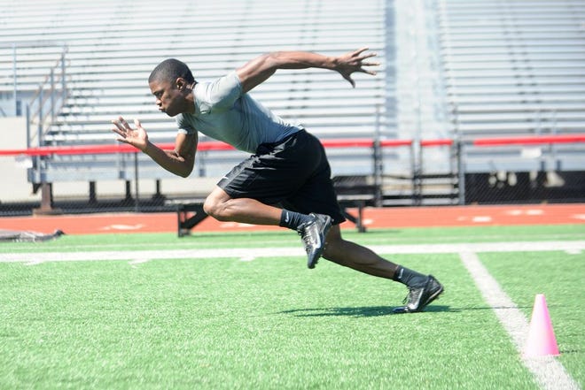 Former Brockton High School student Al Louis-Jean runs drills for scouts from the Chicago Bears and New England Patriots in Marciano Stadium in Brockton on Thursday, April 3, 2014. (Emily J. Reynolds/The Enterprise)