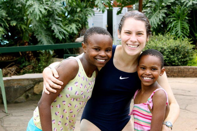 Savannah Kacher with two of the Flying Kites children during her second trip to Kenya in 2010.