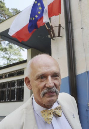 FILE-In this May 25, 2014 file photo, Janusz Korwin-Mikke, leader of a small far right and eurosceptic party leaves a polling station after voting in the European Parliament elections near Warsaw, Poland. Chosen a European lawmaker, he has repeatedly made comments that have outraged other lawmakers. The president of the EU parliament opened an investigation Thursday, March 2, 2017 into his comments that "women must earn less than men because they are weaker, they are smaller, they are less intelligent." He can be reprimanded fined or temporarily suspended for such comments. He recently said in Warsaw that it is a "20th-century stereotype that women have the same intellectual potential as men." (AP Photo/Alik Keplicz)