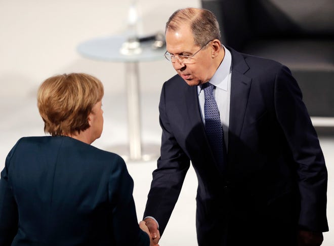 Russian Foreign Minister Sergey Lavrov greets German Chancellor Angela Merkel during the Munich Security Conference in Munich, Germany, Saturday, Feb. 18 2017.