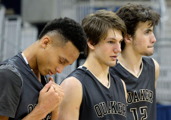 Quaker Valley's Coletrane Washington, Wolf Moser and Danny Conlan react to the Quakers' loss to New Castle in the WPIAL Class 4A boys basketball championship Saturday at Petersen Events Center in Pittsburgh.