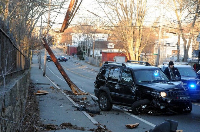 An SUV snapped a utility pole in half at 300 Centre St., in Brockton on Saturday, March, 4, 2017. The driver fled the scene on foot.