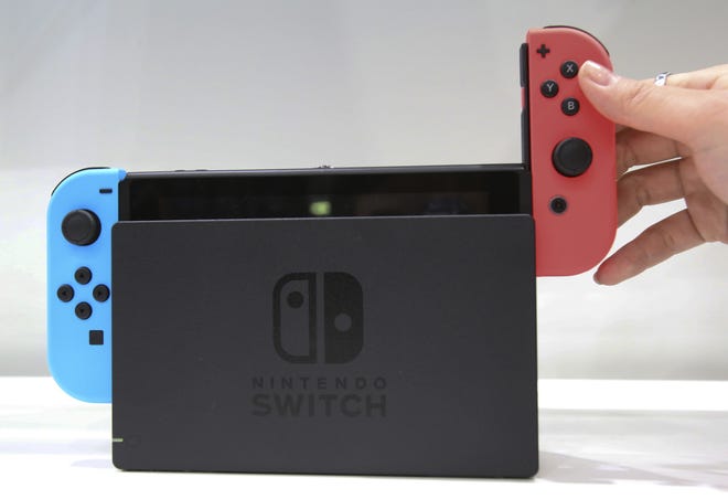 Controllers can be attached to the Nintendo Switch, which is designed to be played both at home and on the road. [ASSOCIATED PRESS ARCHIVE]