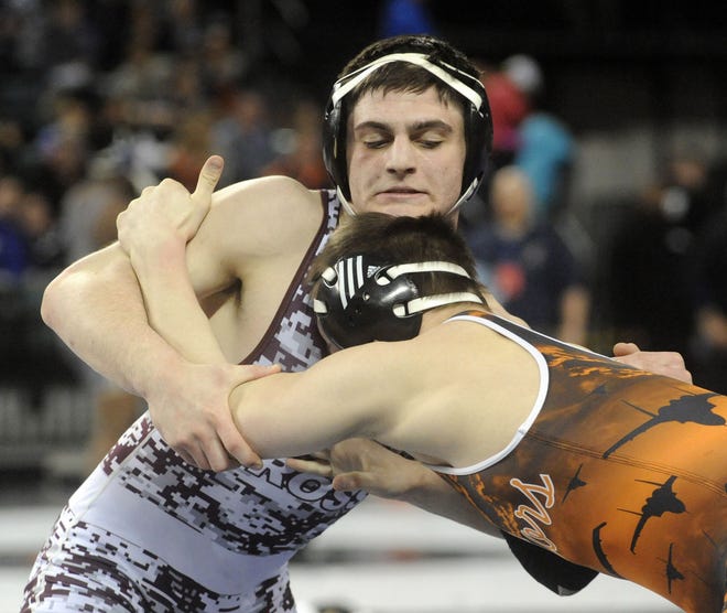 Holy Cross' Avery DiNardi tangles with Hasbrouck Heights' Michael O'Malley in the 152-pound state quarterfinal match Saturday. DiNardi lost in the quarters but rebounded for two wrestleback victories on his way to sixth place in the state.