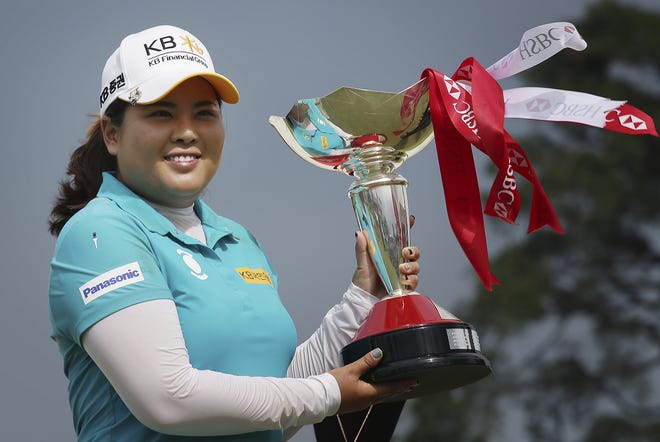 Inbee Park of South Korea poses with her trophy after winning the HSBC Women's Champions golf tournament held at Sentosa Golf Club's Tanjong course on Sunday in Singapore. [WONG MAYE-E / ASSOCIATED PRESS]