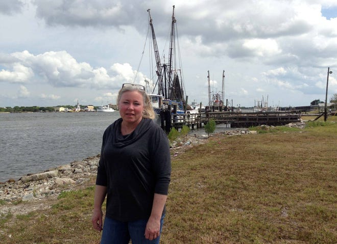 Mikki Baldwin, president of the Mayport Civic Association, stands on a portion of waterfront land owned by the Jacksonville Port Authority. She wants to see a riverfront promenade that gives people an up close look at the village’s fishing heritage. (Photo by David Bauerlein)