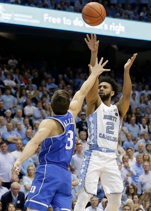 North Carolina's Joel Berry shoots over Duke's Grayson Allen during the first half of Saturday night's game.