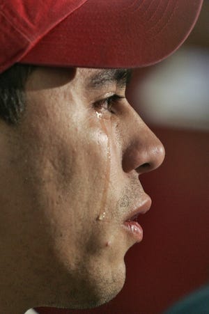 In this 2007 file photo, tears stream down the face of Carlos Miranda as he speaks about his wife who has was detained the day before, leaving their 8-month-old daughter. [PETER PEREIRA/THE STANDARD-TIMES/SCMG]