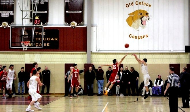 OCV’s Jake Jason buries a three-pointer over Connolly’s Alec Kfoury (No. 15) to trigger the Cougars’ decisive third-period surge Saturday night.

[Wicked Local Photo/Chris Shott]
