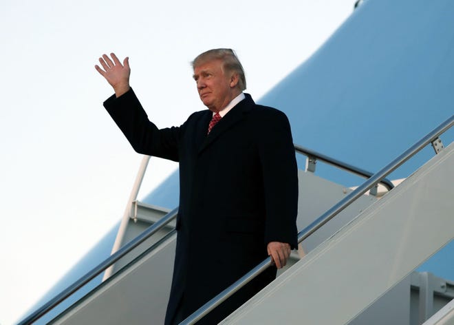President Donald Trump waves as he disembarks Air Force One as he arrives Sunday, March 5, 2017, at Andrews Air Force Base, Md. Trump is returning from Mar-a-Largo, Fla. (AP Photo/Alex Brandon)