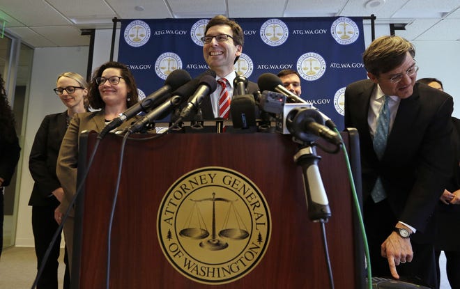 Washington State Attorney General Bob Ferguson smiles during a news conference about President Trump's new executive order Monday, March 6, 2017, in Seattle. Trump signed an executive order Monday ordering new travel restrictions for residents of six Muslim-majority countries as well as a temporary ban on refugees from around the world, retooling a directive issued five weeks ago that stoked chaos at airports and drew international condemnation and a rebuke in the federal courts. The new ban, which takes effect March 16, halts travel for 90 days for residents of Iran, Libya, Somalia, Sudan, Syria and Yemen. (AP Photo/Elaine Thompson)