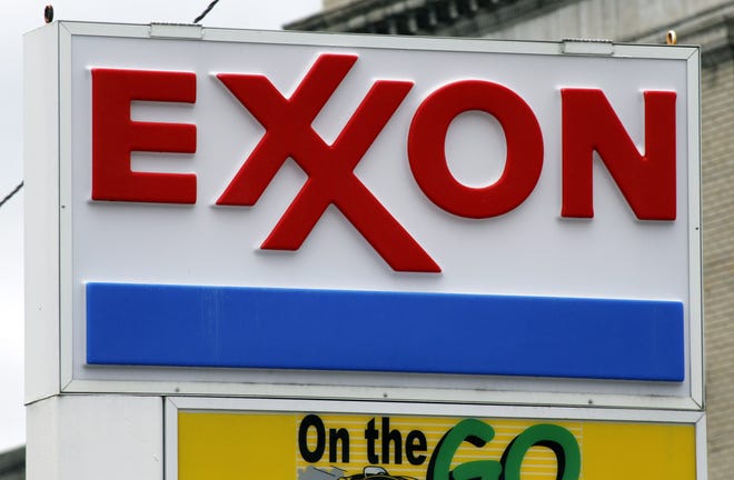 FILE - This April 29, 2014, file photo shows an Exxon sign at a mini-mart in Dormont, Pa. Exxon Mobil Corp. is fighting against government investigators who believe the company covered up knowledge of how fossil fuels contribute to climate change. Exxon went to state court in Texas on Wednesday, April 13, 2016, to seek to quash a subpoena issued last month by the attorney general of the U.S. Virgin Islands. The company says the investigation violates its constitutional rights to speak freely and to be protected from unreasonable searches and seizures.(AP Photo/Gene J. Puskar, File)