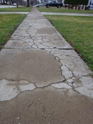 Cracked and broken sidewalks along Oakwood Avenue have been marked for repair. The city plans to spend $100,000 fixing sidewalks on Oakwood.