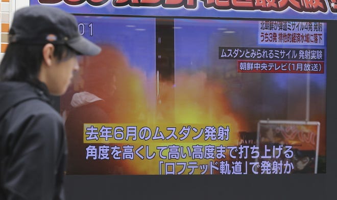 A man walks past a screen showing a TV news on North Korea's missile firing, in Tokyo, Monday, March 6, 2017. North Korea on Monday fired four banned ballistic missiles that flew about 1,000 kilometers (620 miles), with three of them landing in Japan's exclusive economic zone, South Korean and Japanese officials said. (AP Photo/Koji Sasahara)
