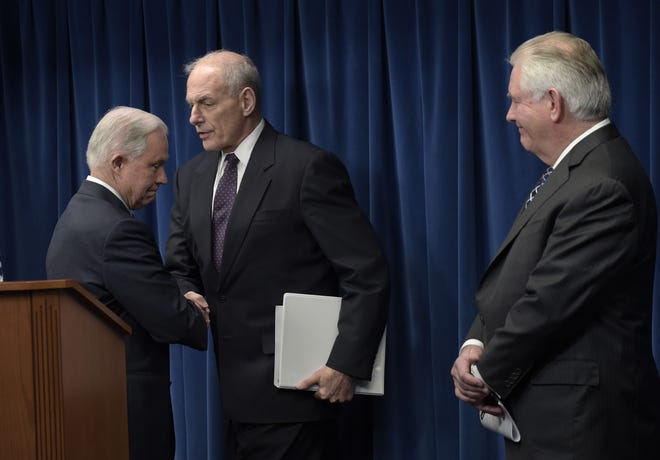Homeland Security Secretary John Kelly, center, shakes hands with Attorney General Jeff Sessions, left, as Secretary of State Rex Tillerson watches at right, as they take turns making statements on issues related to visas and travel, Monday, March 6, 2017, at the U.S. Customs and Border Protection office in Washington. THE ASSOCIATED PRESS