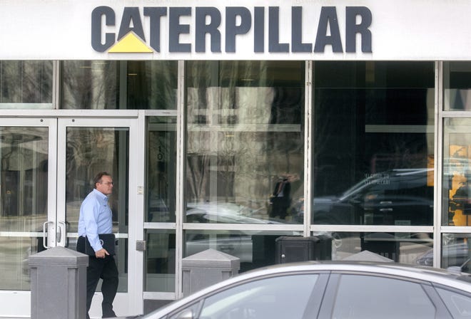 Steve Settingsgaard, head of North American security for Caterpillar Inc., walks past the entrance to the company's world headquarters on Thursday, March 2, 2017, in Peoria, Ill. Federal law enforcement officials executed a search warrant at three Caterpillar facilities in central Illinois on Thursday. (Matt Dayhoff/Journal Star via AP)