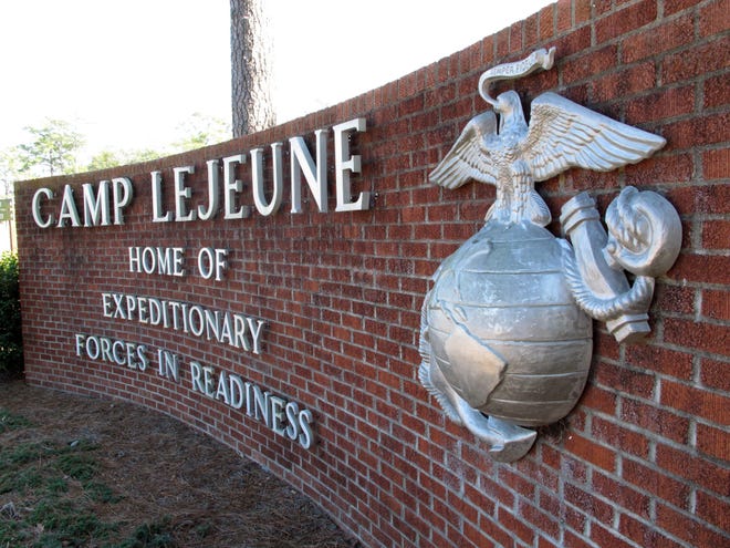 FILE - In this March 19, 2013 file photo, the globe and anchor stand at the entrance to Camp Lejeune, N.C. The Obama administration has agreed to provide disability benefits totaling more than $2 billion to veterans who had been exposed to contaminated drinking water while assigned to Camp Lejeune in North Carolina. (AP Photo/Allen Breed, File)