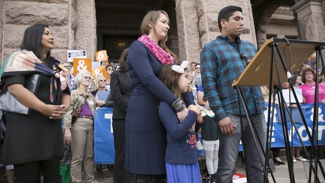 Frank Gonzales speaks about his transgender daughter, Libby, 6 (shown with her mother, Rachel), during a news conference by the Transgender Education Network of Texas at the Capitol on Monday. DEBORAH CANNON / AMERICAN-STATESMAN