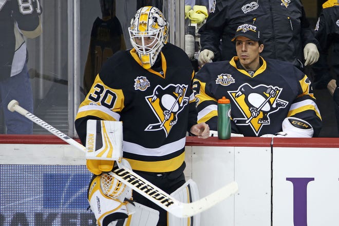 Penguins goalie Matt Murray (30) takes a timeout with goalie Marc-Andre Fleury (29) on the bench against the Tampa Bay Lightning on Friday in Pittsburgh.