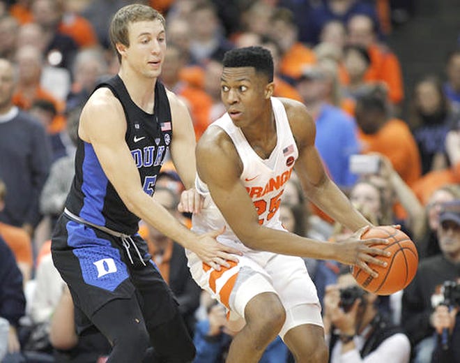 Syracuse's Tyus Battle (right) looks to pass the ball as Duke's Luke Kennard defends during the first half of a Feb. 22 game in Syracuse, New York. Battle and the Orange have a bye for the first round of the ACC tournament and will play at noon Wednesday against Miami.   

[Nick Lisi/AP]