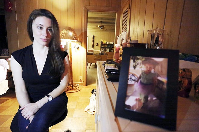 In this Feb. 13 photo, Casey Anthony poses for a portrait next to a photo of her daughter, Caylee, in her West Palm Beach, Fla., bedroom. In an exclusive interview with The Associated Press, Anthony claims the last time she saw Caylee she “believed that she was alive and that she was going to be OK.” [JOSHUA REPLOGLE/AP]