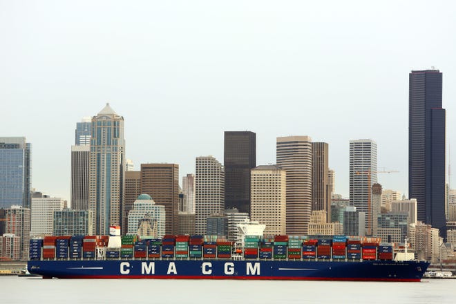 In this Monday, Feb. 29, 2016, photo, the CMA CGM Benjamin Franklin is towed to Seattle's Terminal 18. The vessel is 1,300 feet long, 177 feet wide, 197 feet high and can carry up to 18,000 containers. On Tuesday, March 7, 2017, the Commerce Department reports on the U.S. trade deficit for January. (Genna Martin/seattlepi.com via AP)