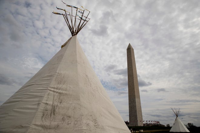 A group protesting the Dakota Access oil pipeline has set up teepees on the National Mall near the Washington Monument in Washington, Tuesday, March 7, 2017. A federal judge declined to temporarily stop construction of the final section of the disputed Dakota Access oil pipeline, clearing the way for oil to flow as soon as next week. (AP Photo/Andrew Harnik)