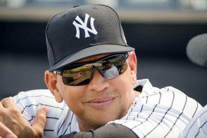 FILE - In this Feb. 24, 2017, file photo, New York Yankees special advisor Alex Rodriguez speaks with CC Sabathia, who reflected in his sunglasses, ahead of a spring training baseball game against the Philadelphia Phillies in Tampa, Fla. (AP Photo/Matt Rourke, File)