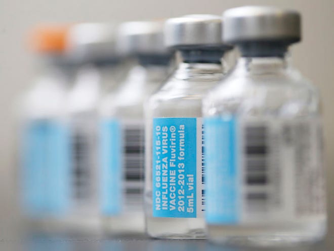 FILE-This Thursday, Jan. 10, 2013 file photo shows vials of flu vaccine in Philadelphia. (AP Photo/Matt Rourke)
