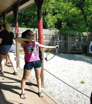 Neisha Torres, of Devol, takes part in an archery class at Camp Corral, a summer camp for the children of veterans. [Photo provided]