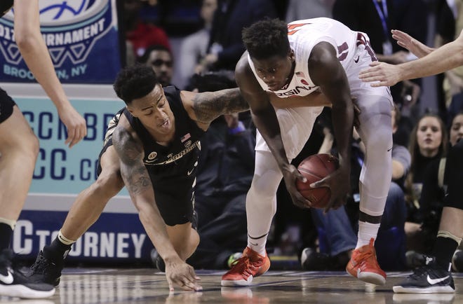 Wake Forest forward John Collins (20) and Virginia Tech forward Khadim Sy (2) scramble for a loose ball during the first half of an NCAA college basketball game in the second round of the ACC tournament, Wednesday, March 8, 2017, in New York. (AP Photo/Julie Jacobson)