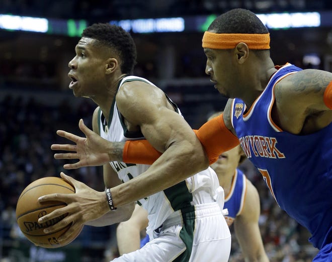 Bucks' Giannis Antetokounmpo, left, is fouled by Knicks' Carmelo Anthony during the second half of Wednesday night's game in Milwaukee. [The Associated Press]