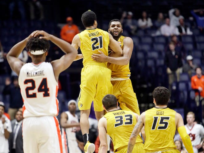 Kevin Puryear, right, celebrates with a teammate after hitting the game-winning shot against Auburn in the SEC Basketball Tournament in Nashville, Tenn.