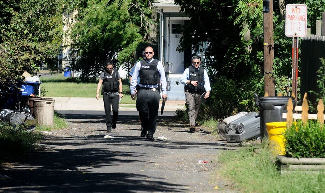 Florence police and detectives from the Burlington County Prosecutor's Office's major crimes unit walk down Zinc Street in Florence while investigating a homicide on Thursday, Sept. 22, 2016. Florence police discovered the victim with a gunshot wound to his chest on Zinc Street, an alley that runs between West Second and Third streets Wednesday evening.