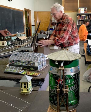 Rich Bowen of Falls, a member of the Southeastern Pennsylvania Garden Railway Society, works on the group's display for the Philadelphia Flower Show, which runs through Sunday.