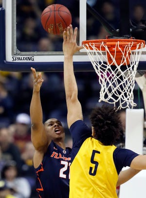 Illinois guard Malcolm Hill (21) has his shot blocked by Michigan forward D.J. Wilson (5) during the first half of an NCAA college basketball game in the Big Ten Conference tournament, Thursday, March 9, 2017, in Washington. (AP Photo/Alex Brandon)