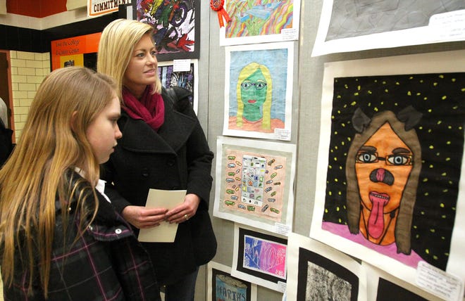 Amy Shores (right) of Freeport looks at artwork with her daughter Rebecca during the World Arts Festival held Thursday, March 9, 2017, at Freeport High School in Freeport. [JANE LETHLEAN/THE JOURNAL-STANDARD CORRESPONDENT]