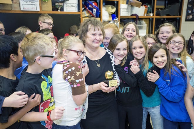 Linda Julian celebrates with her students after she was presented with a Golden Apple Award for Excellence in Education by Paul Gaier of the Rockford Register Star on Thursday, March 9, 2017, at Willowbrook Middle School. [ARTURO FERNANDEZ/RRSTAR.COM STAFF]