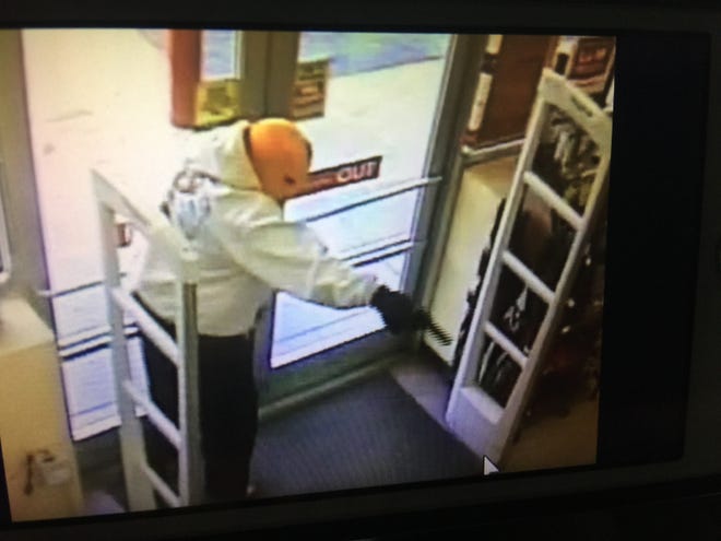 Surveillance cameras captured a gunman inside the Atkinson Family Dollar on Friday during a robbery. 

[CONTRIBUTED PHOTO]