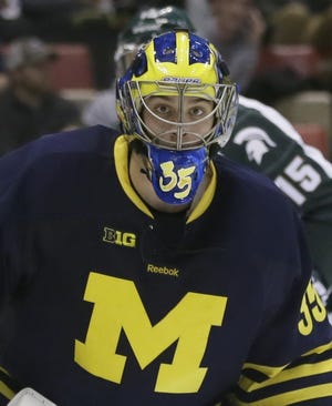 Michigan goalie Zach Nagelvoort guards the net during the second period of an NCAA college hockey game against Michigan State, Friday, Jan. 30, 2015 in Detroit. (AP Photo/Carlos Osorio)