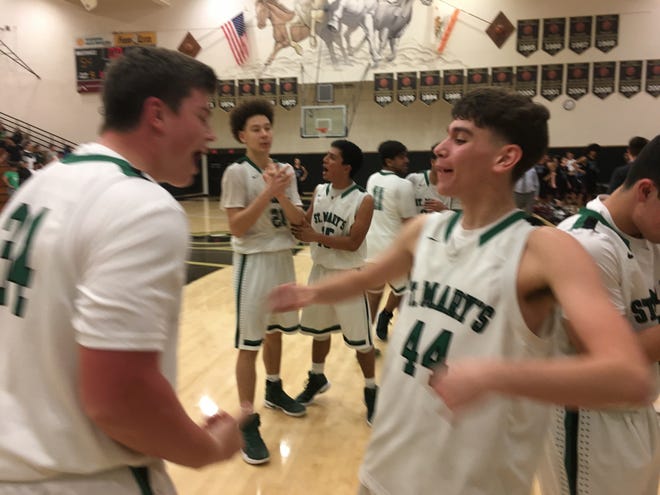 St. Mary's teammates Cole Norgaard, left, and Carson Simi, right, celebrate after their team beat Folsom 54-53 in a CIF NorCal Division I quarterfinal Saturday at Delta College's Blanchard Gym in Stockton. [THOMAS LAWRENCE/THE RECORD]