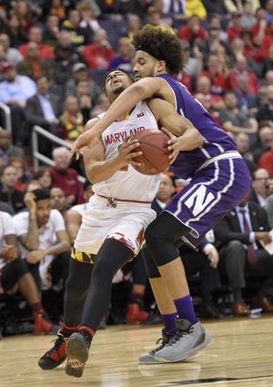 Maryland guard Melo Trimble (left) is fouled by Northwestern center Barret Benson during the second half in the Big Ten tournament on Friday, March 10, 2017, in Washington. Northwestern won 72-64. [NICK WASS/THE ASSOCIATED PRESS]