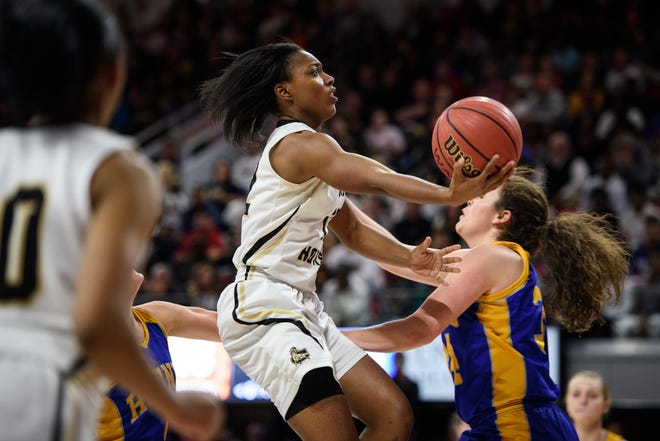 Clinton's Mikayla Boykin goes for a layup in front of North Surry's Martha Holt in the fourth quarter during the NCHSAA 2-A State championship game on Saturday, March 11, 2017, in Raleigh. [Staff Photo by Andrew Craft]