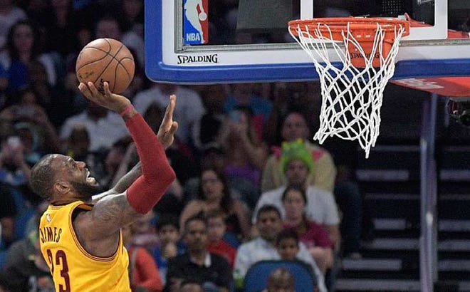 LeBron James (23) goes up for a shot during the second half Saturday's game against the Magic in Orlando, Fla.