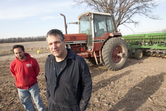 Peter Klees, right, and son Kyle Klees, plant seeds March 4 at one of their farms near Stronghurst, Ill. Kyle Klees grew up farming with his father, and left school at Southeastern Community College after buying his first farm.