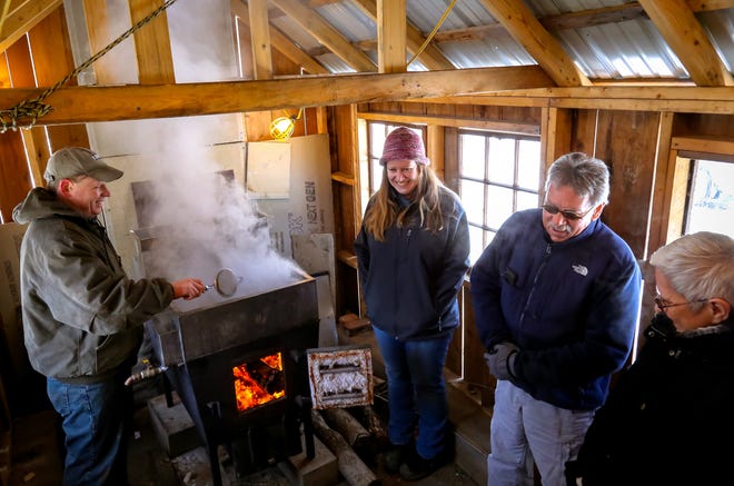 From left, Matt Scruton, Gretchen Scruton and Dennis and Pauline Roseberry talk about the steps of making maple syrup inside the sugar shack at Ten Rod Farm Saturday in Rochester. [Shawn St. Hilaire/Fosters.com]