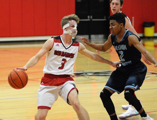 Spaulding High School senior guard Griffin Towle, left, has had to play the second half of the Division I season with a protective mask after fracturing his jaw in December. [Mike Whaley/Fosters.com]