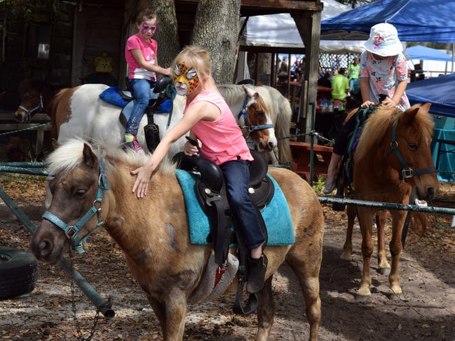 Hannah Thomas, 6, rides a horse during the Fruitville Grove Berry Festival on Sunday, March 12, 2017. [HERALD-TRIBUNE STAFF PHOTO / CARLOS R. MUNOZ]